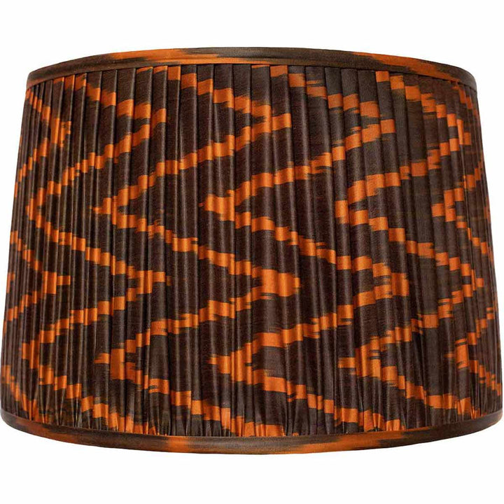 Mekhann's large brown and orange ikat silk lampshade, a statement piece hand-pleated with eco-friendly dyes for an opulent effect.