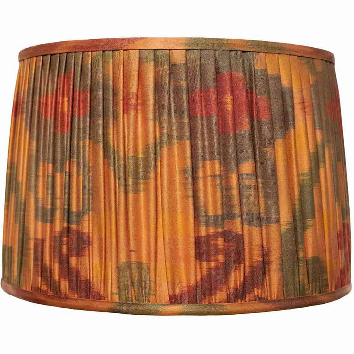 Mekhann's large orange ikat silk lampshade, a statement piece with hand-pleated detail, coloured with sustainable dyes for a striking effect.