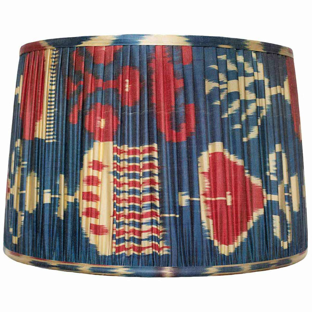 Mekhann's larger red and blue ikat silk lampshade, a bold decor element, hand-pleated with eco-conscious dyes for a striking effect.