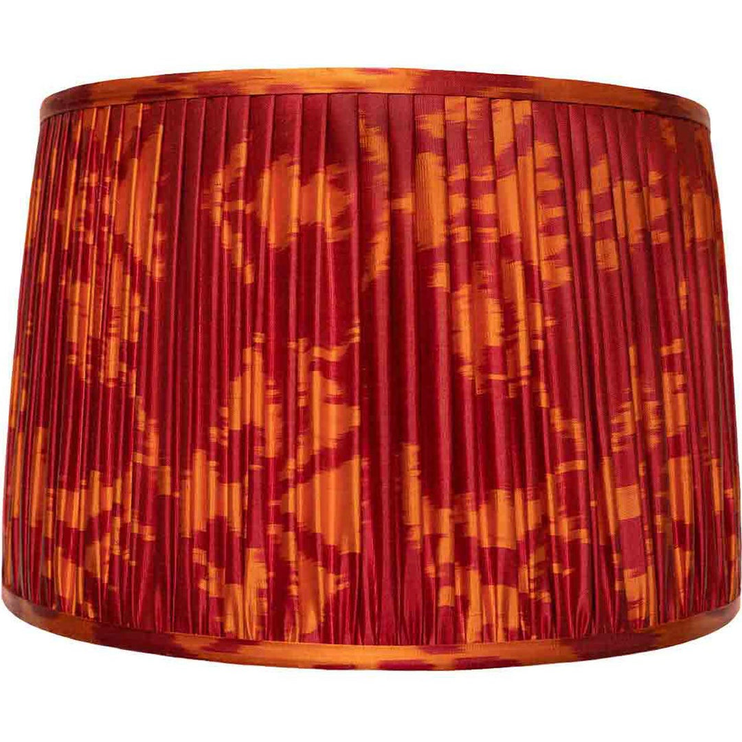 Large red and orange ikat silk lampshade from Mekhann, a bold statement piece, hand-pleated and dyed with eco-friendly practices.