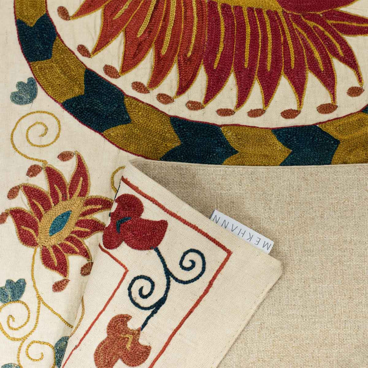 Folded view of Mekhann's cream lotus runner, showcasing the back lining of the runner with the Mekhann label addition.