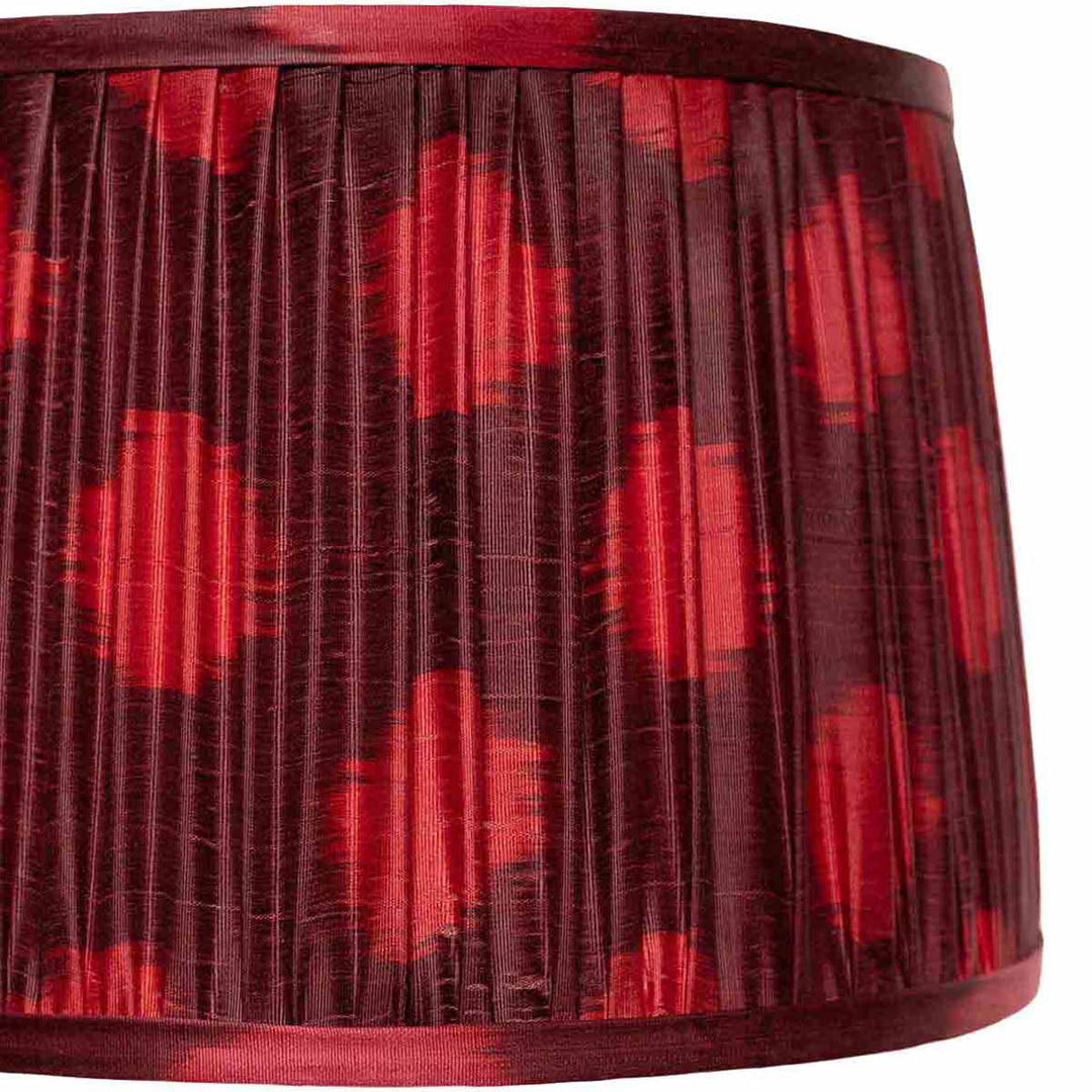 Close-up of the maroon ikat lampshade from Mekhann, highlighting the unique dot pattern and the texture of the hand-pleated silk.