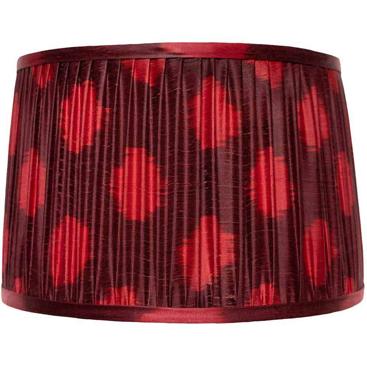 Front view of Mekhann's maroon ikat silk lampshade, featuring a dotted pattern hand-pleated with natural dyes for an elegant look.