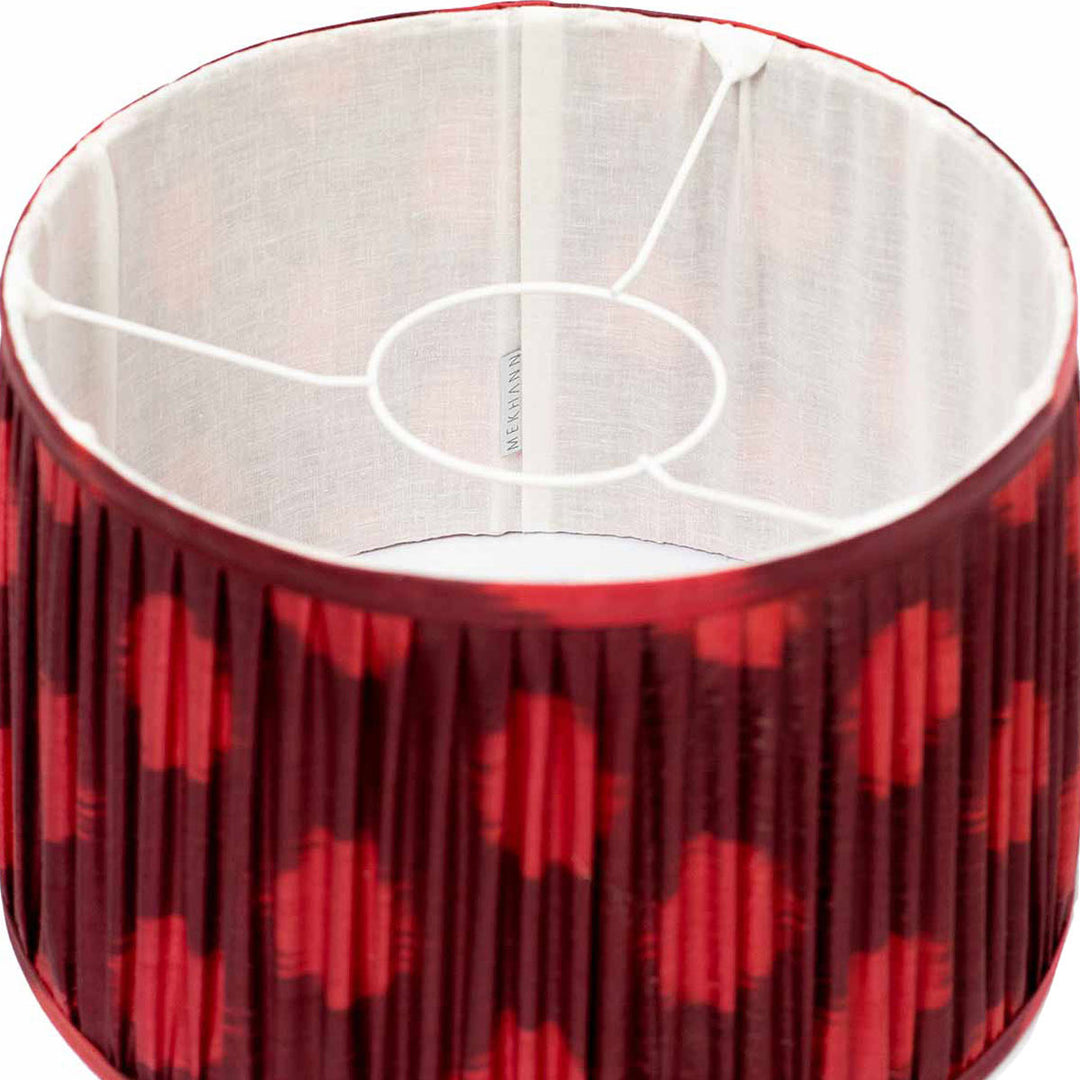 Interior perspective of Mekhann's maroon ikat lampshade, showing the fine silk fabric and the distinctive dotted ikat design.