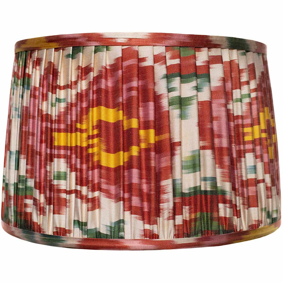 Front view of Mekhann's multicolour ikat silk lampshade, with a vibrant mix of red, green, and yellow hand-pleated with eco-friendly dyes.