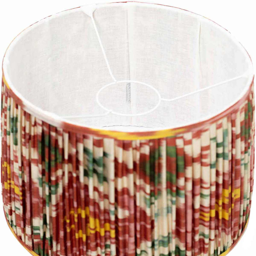 Interior view of Mekhann's silk lampshade, showcasing the rich tapestry of multicolour ikat patterns against the lustrous silk fabric.