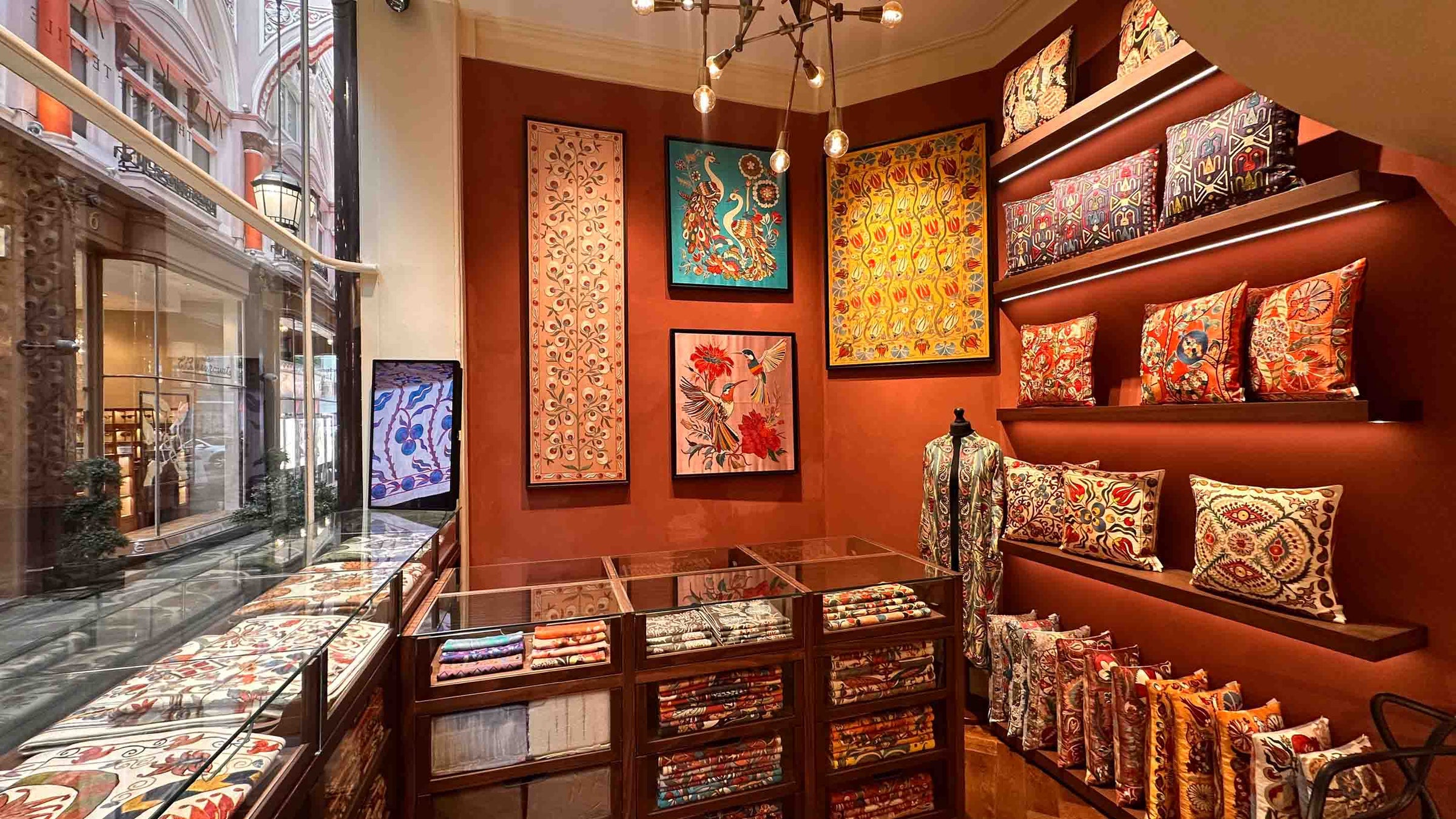 Decorative store interior with colorful pillows and wall art.