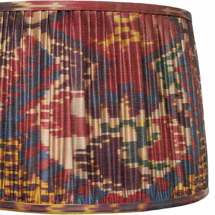 Close-up detail of Mekhann's ikat lampshade, highlighting the vivid colours and precision of the hand-pleating technique.