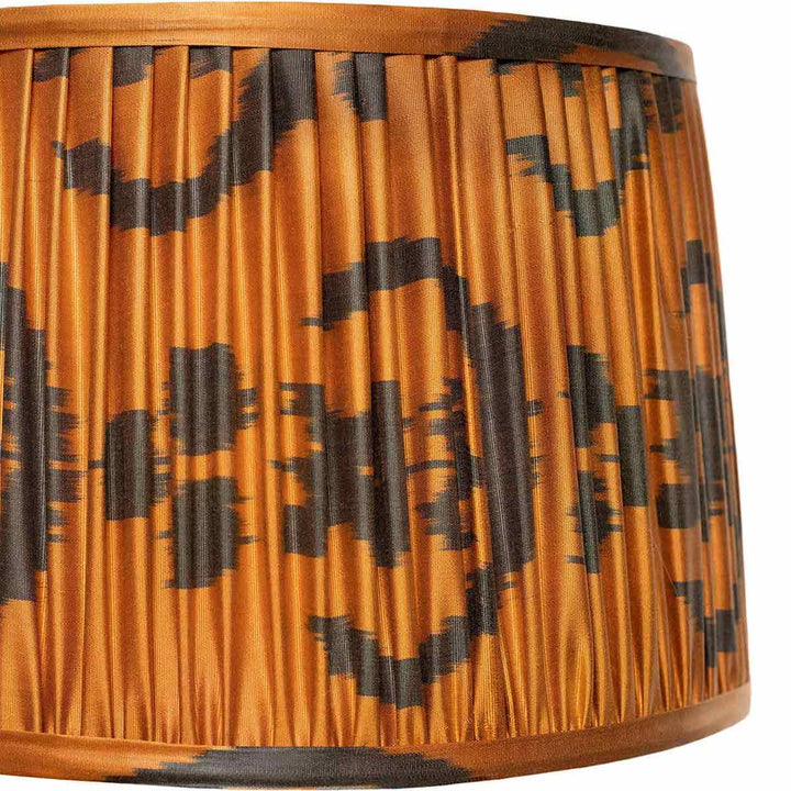 Detailed close-up of Mekhann's orange ikat lampshade, with emphasis on the intricate pattern and eco-friendly dyes.