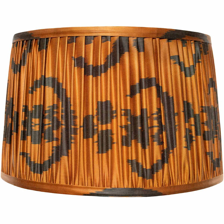 Front view of Mekhann's orange silk ikat lampshade, hand-pleated with natural, plant-based dyes for a vibrant look