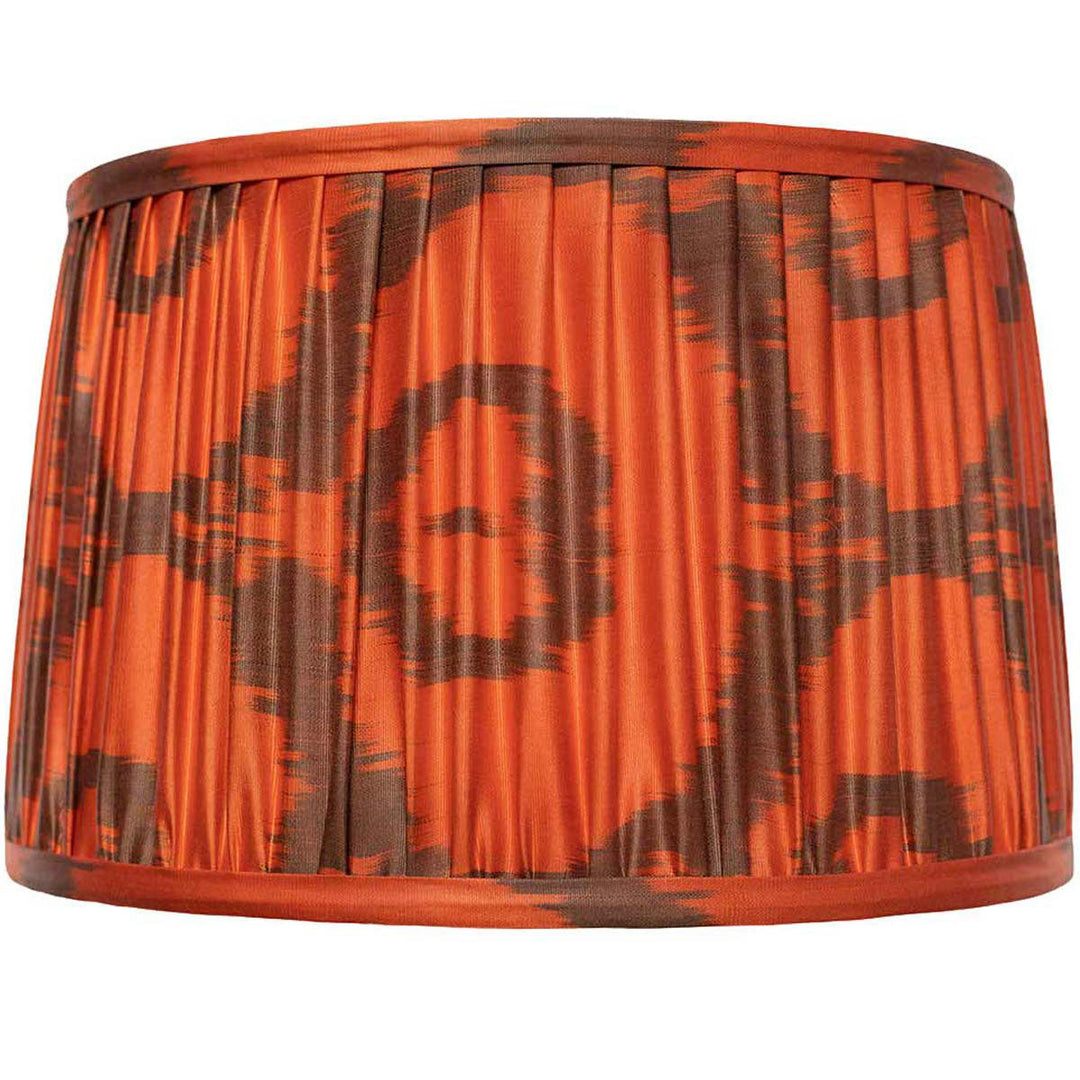 Front view of Mekhann's orange ikat silk lampshade, hand-pleated with organic dyes for a lively interior accent.