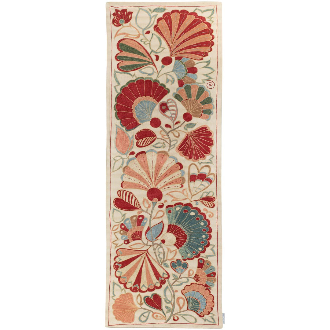 Front view of Mekhann's cream petals runner, adorned with a vibrant display of red and teal fan-shaped floral designs that have been hand embroidered with light blue and red as they stand out coloured, onto a canvas of cream coloured silk.