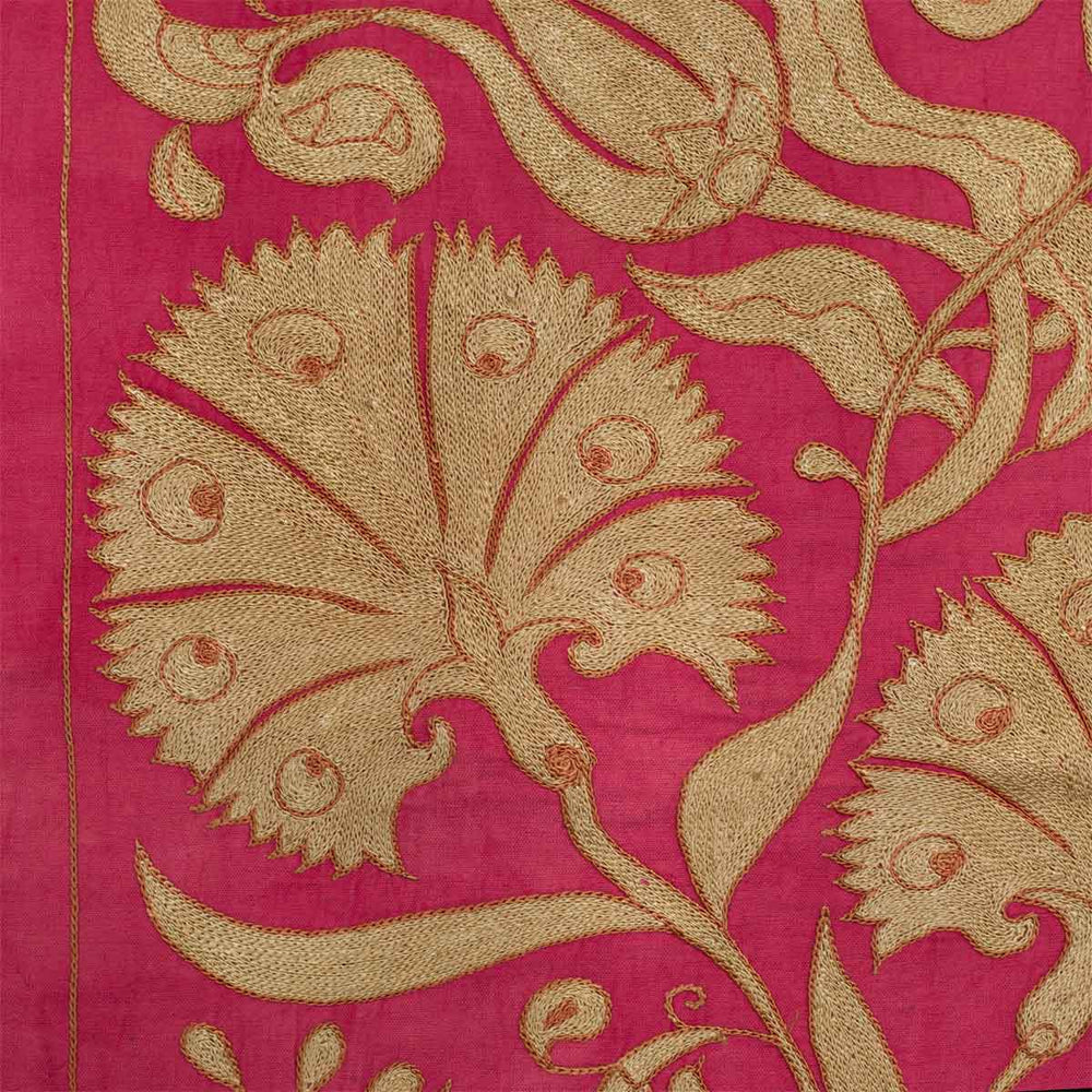 Close up view of Mekhann's pink ottoman vines runner, showing one of the embroidered carnation flowers in detail where you can see the embroidered texture of the runner.