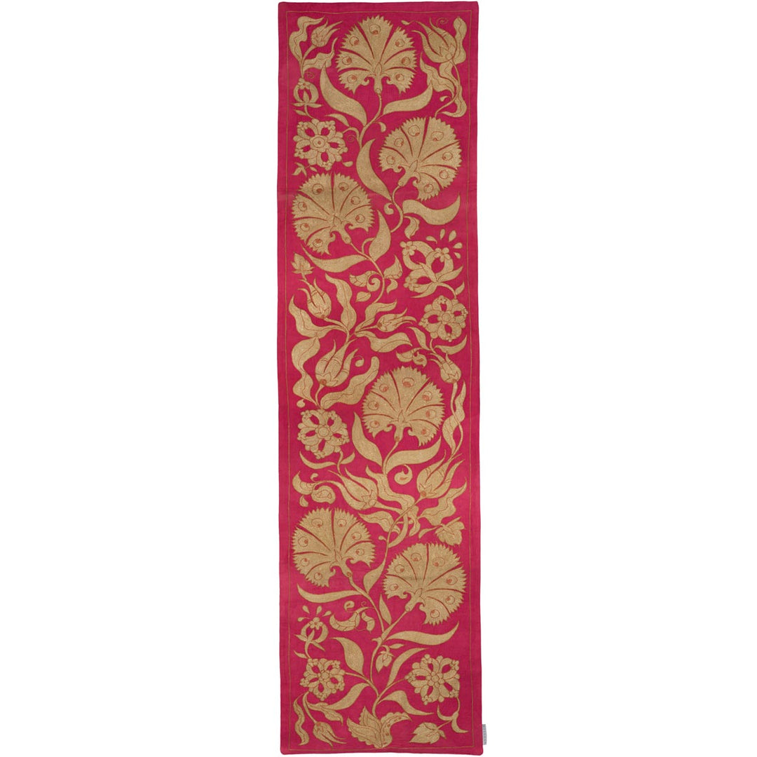 Front view of Mekhann's pink ottoman vines runner, with a display of beige floral and fruit patterns hand embroidered in beige and set against a bright pink silk background.