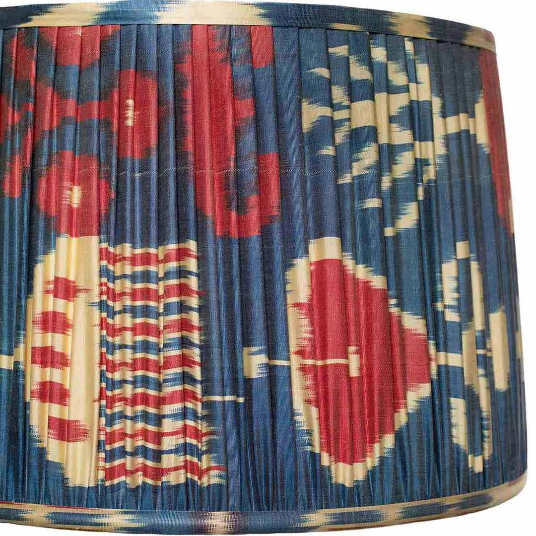 Close-up of the red and blue ikat pattern on Mekhann's lampshade, highlighting the hand-dyed detail and texture.