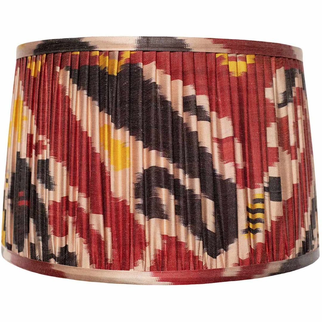 Front view of Mekhann's red ikat silk lampshade, featuring bold patterns hand-pleated with environmentally friendly dyes.