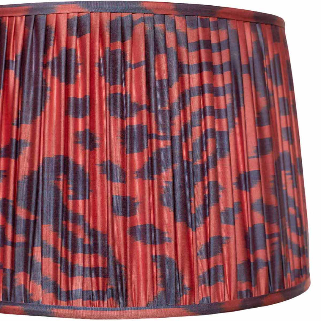 Close-up detail of Mekhann's red and navy ikat lampshade, highlighting the unique pattern and sustainable hand-dyeing technique.
