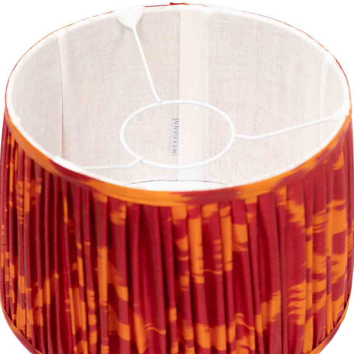 Interior shot of Mekhann's red and orange ikat lampshade, revealing the vibrant silk craftsmanship and dynamic colouring.
