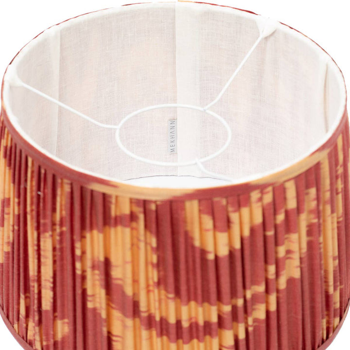 Interior perspective of Mekhann's red and yellow ikat lampshade, displaying the silky texture and rich, eco-friendly colours .