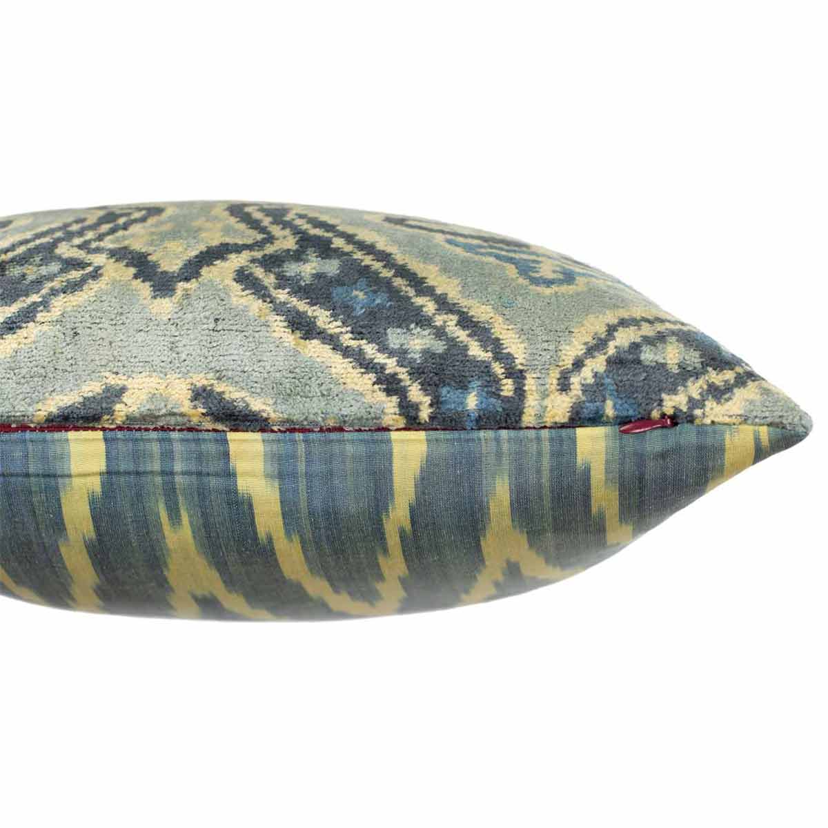 Side view of Mekhann's light green velvet cushion, where we can see how the front of the cushion has been joined to the back of the cushion. We can also see the side zip that would be used to fit a cushion pad.