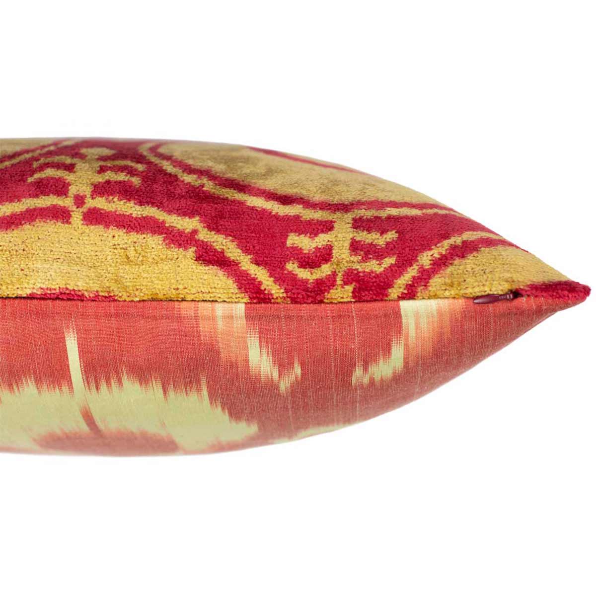 Side view of Mekhann's orange moon velvet cushion, revealing the joining point of the back and front layers of the velvet cushion.