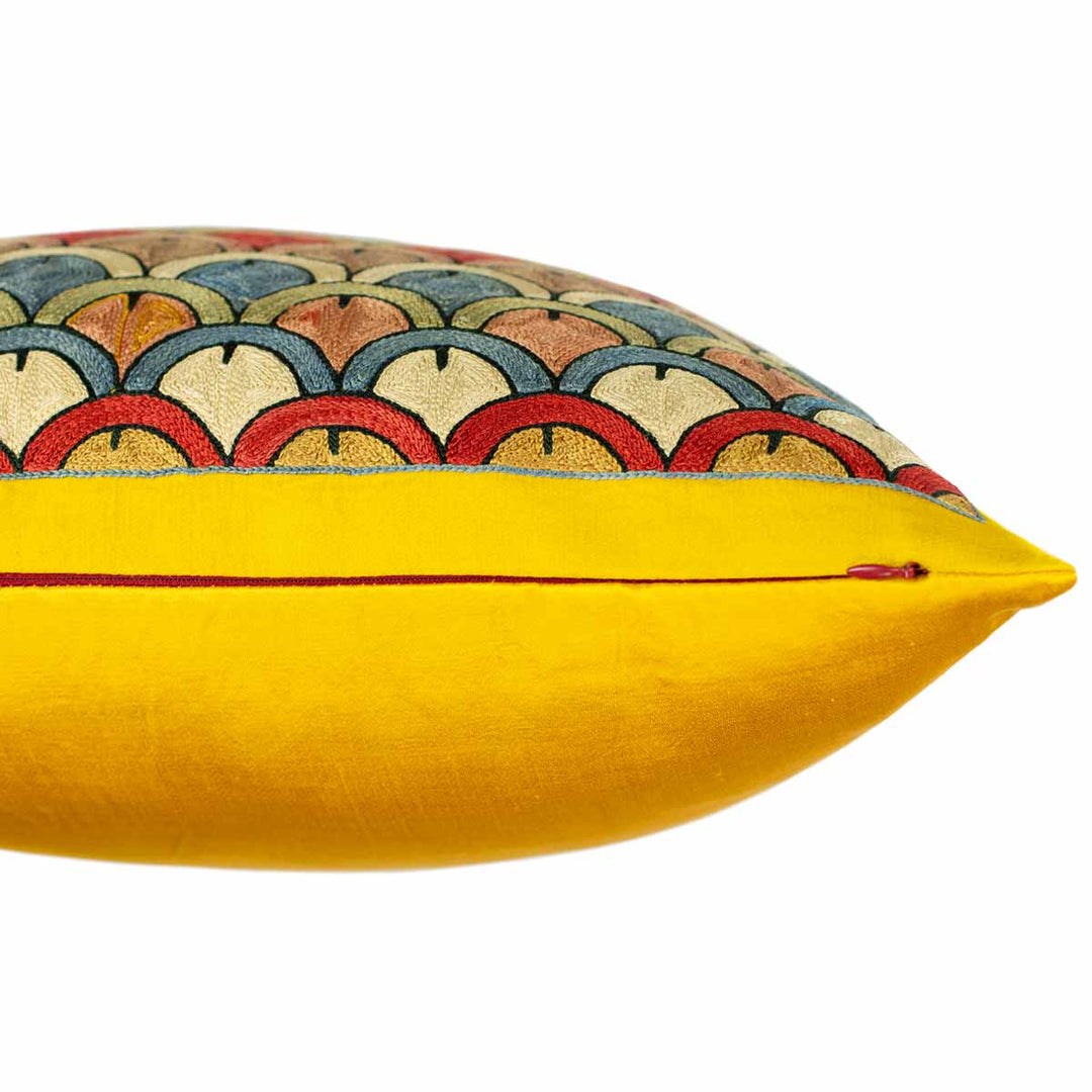 Side view of Mekhann's yellow Domes silk fully embroidered cushion, where we can see where the domes embroidery ends, we are also able to see the red zip on the side.