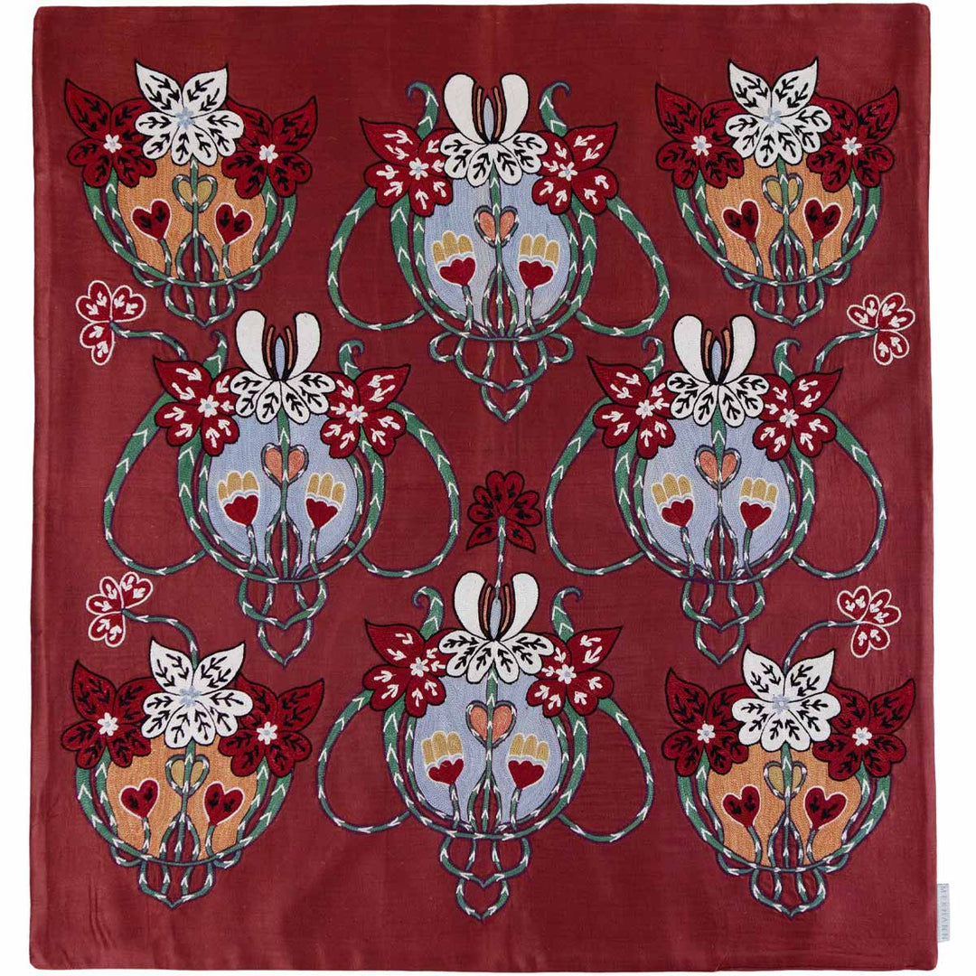 Front view of Mekhann's maroon baroque petite throw, the silk embroidered throw displays a symmetrical pattern of stylised flowers and intricate shapes against a silk maroon background.