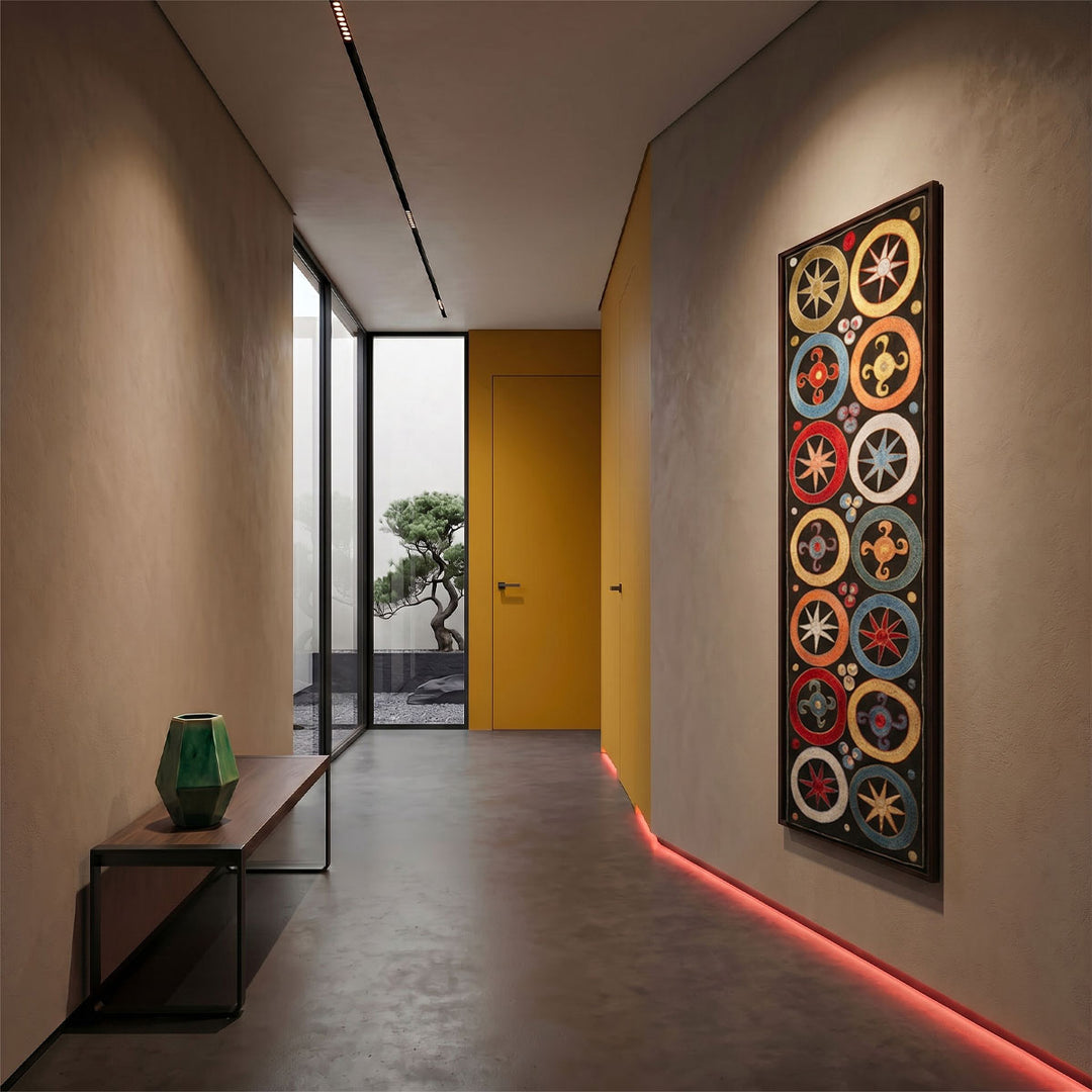 Modern hallway with colorful wall art, a yellow door, and a bench.