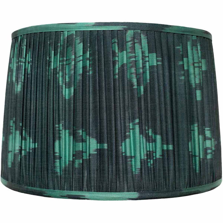 Front view of Mekhann's teal ikat design silk lampshade, displaying hand-pleated elegance and rich, natural dye patterns.