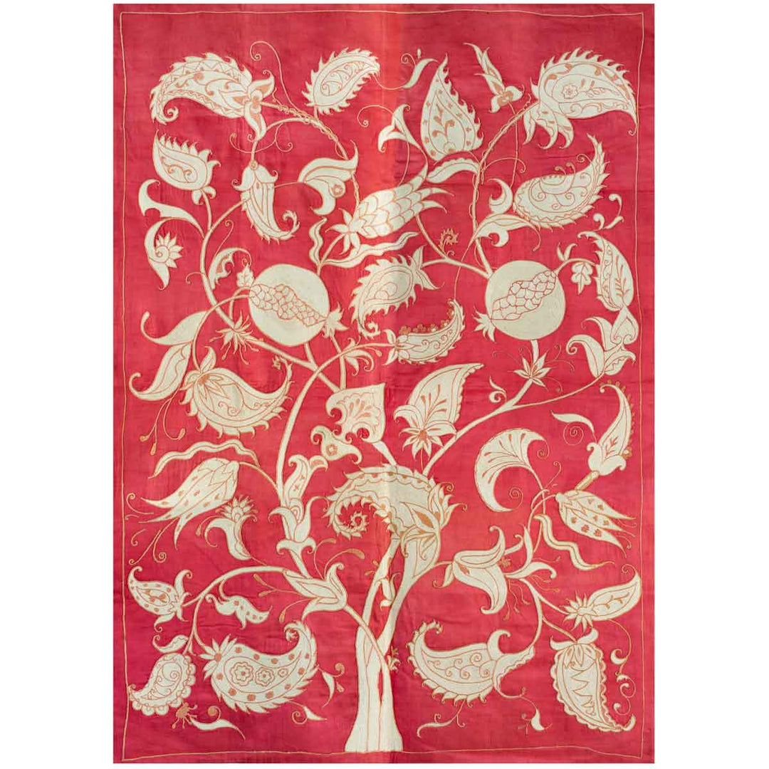 Front view of Mekhann's pink tree of life throw, showcasing the full composition of the tree of life motifs spreading across the throw in cream and orange tones again a silk pink backdrop.