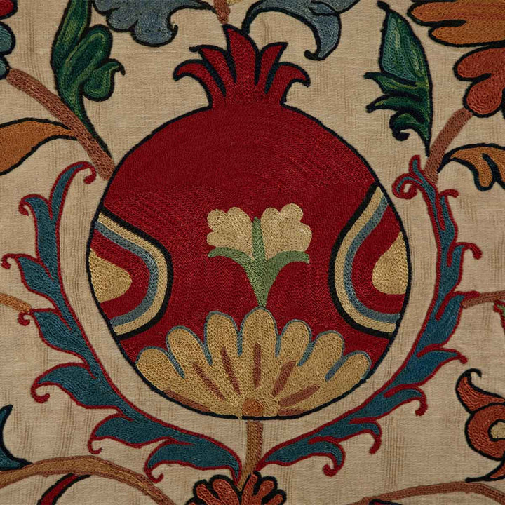 Detailed view of Mekhann's silk tulip petite throw, highlighting the intricate embroidery and vibrant colour palette.