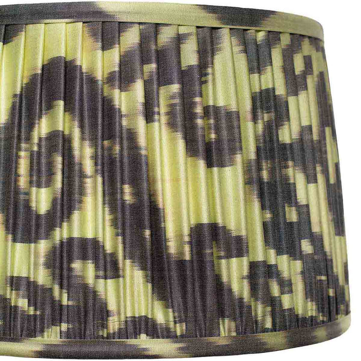 Close-up of Volute’s pleated ikat silk, scrolling motif and fabric-covered binding.