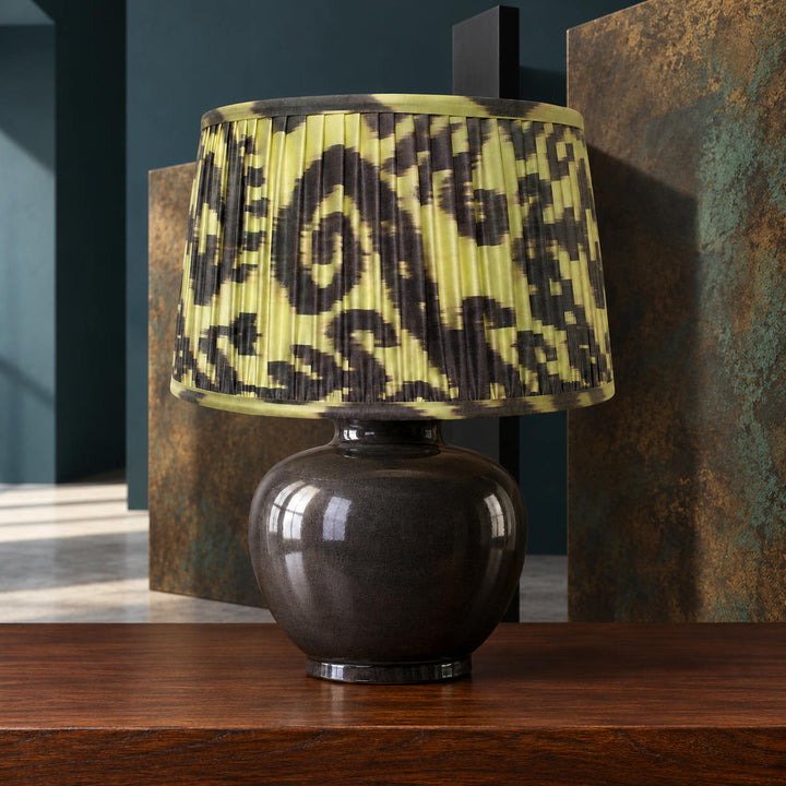 Volute lampshade styled with geometric screens and patinated metal; illustrative architectural setting.