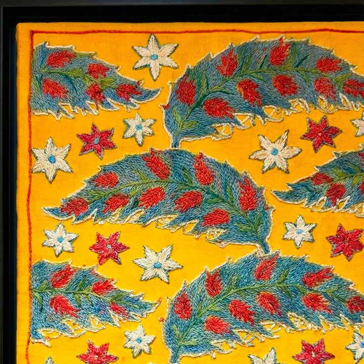 Embroidered fabric with floral patterns on a yellow background