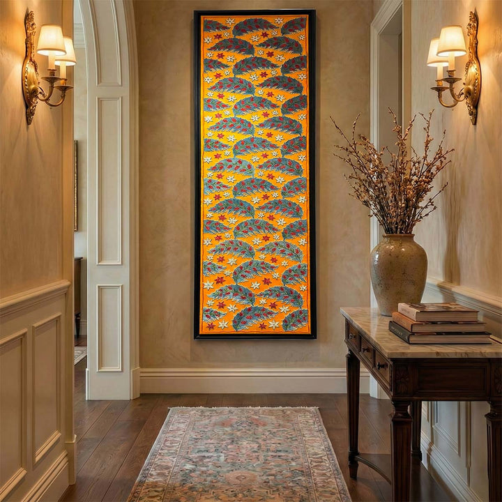Decorative wall art in a hallway with a vase and books on a table.