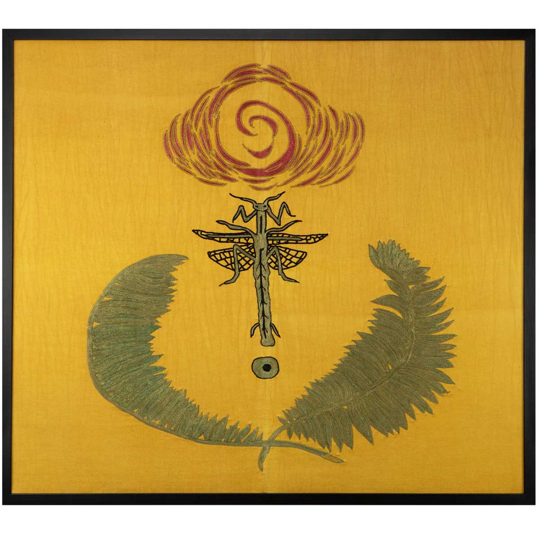 Front view of Mekhann's hand embroidered yellow silk praying mantis artwork, with a design of a green and black outlined praying mantis in between two large green leafs on a yellow silk background.