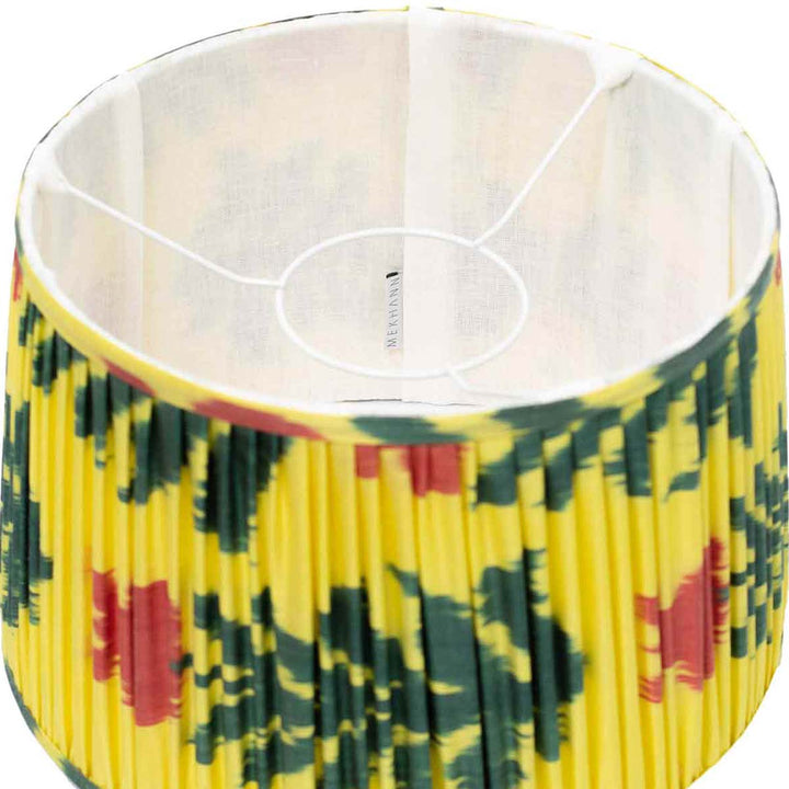Inside view of Mekhann's silk lampshade, revealing the vibrant saffron yellow with green and red floral ikat design detail.