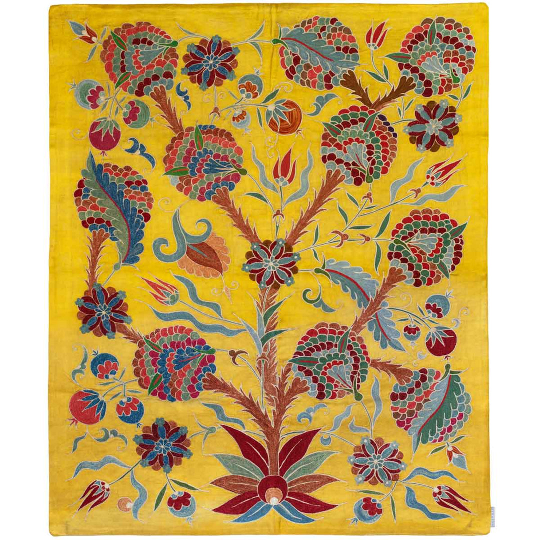 Front view of Mekhann's yellow iznik throw, revealing a collection of hand embroidered iznik style patterns on a silk yellow base. The embroidered patterns are in colours green, red, blue, light brown and deep maroon.