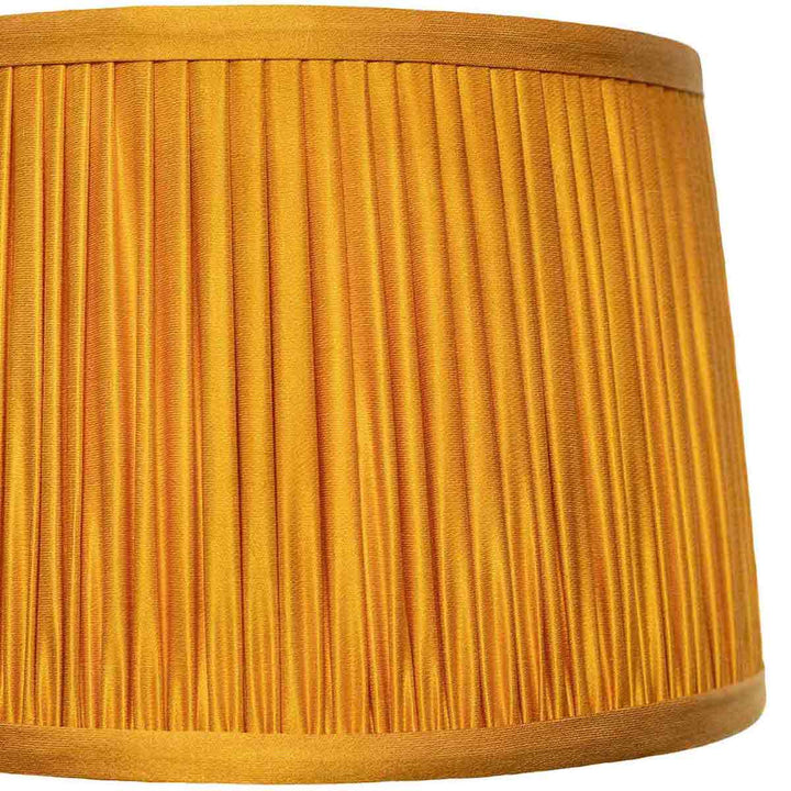 Close-up detail of the elegant pleating on Mekhann's yellow silk lampshade, exemplifying fine craftsmanship.